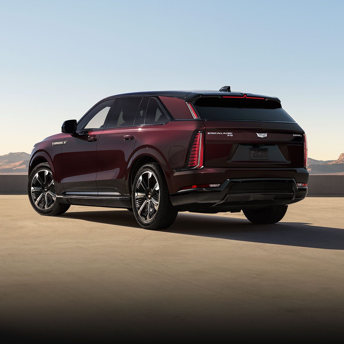 Front View of the Cadillac ESCALADE IQ Parked in a Desert Under a Sunset