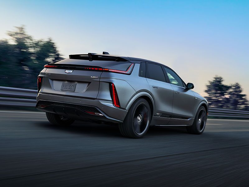 The Rear Three-quarter of a Cadillac LYRIQ Driving Down the Road