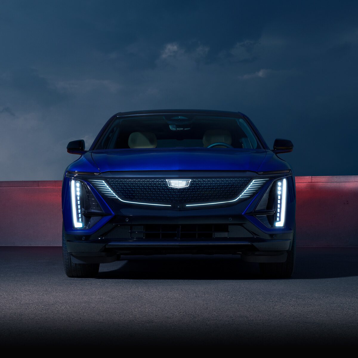 Front View of a Blue Cadillac LYRIQ Parked at Night