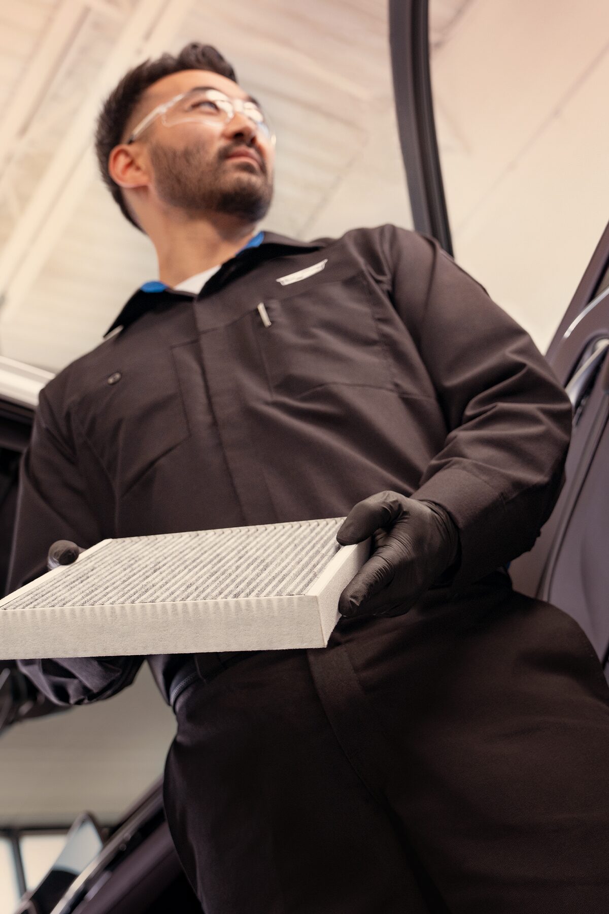Cadillac Certified Service Technician Holding a Vehicle's Cabin Air Filter