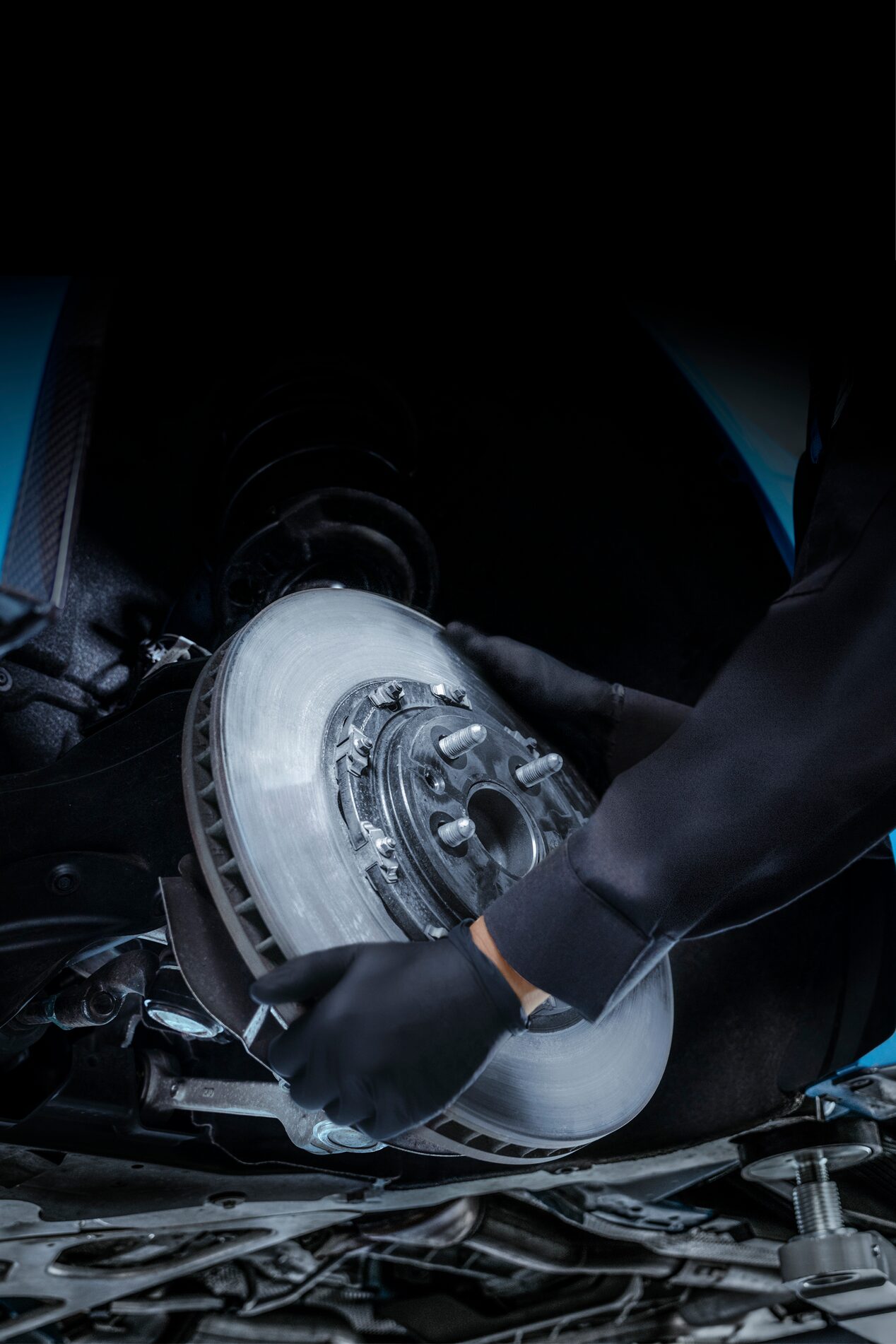 Cadillac Certified Service Technician Replacing a Brake Rotor on a Vehicle