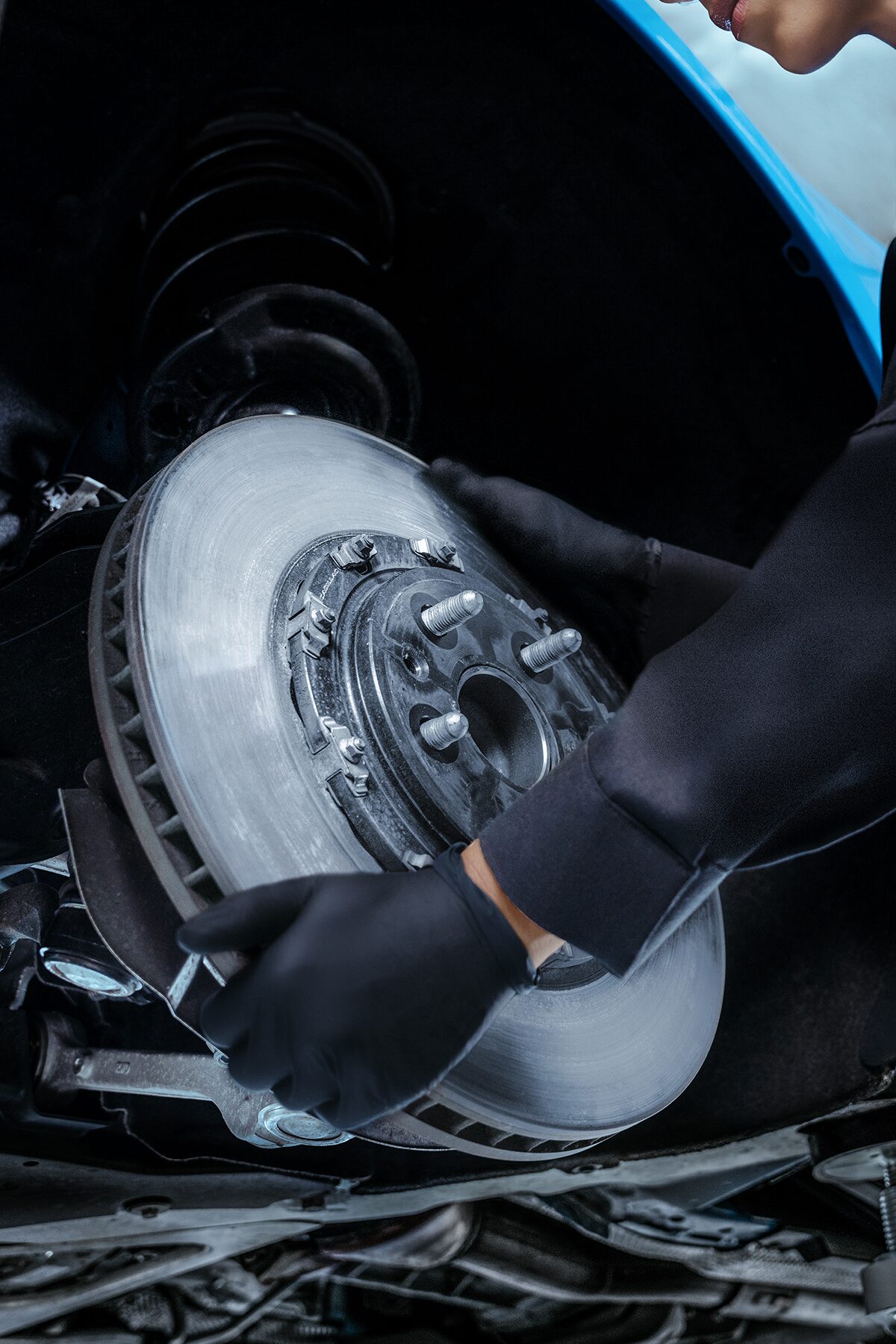 Cadillac Certified Service Technician Replacing a Brake Rotor on a Vehicle