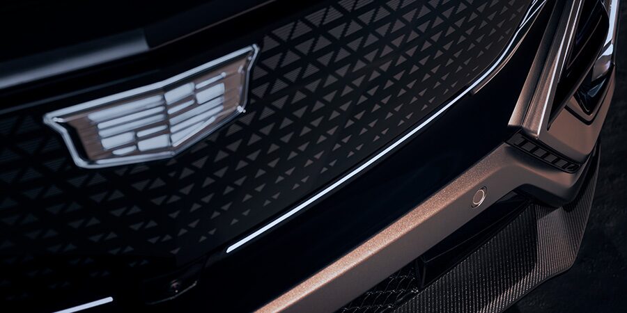 Close-up of a Cadillac Emblem on the Front Grille of a Vehicle