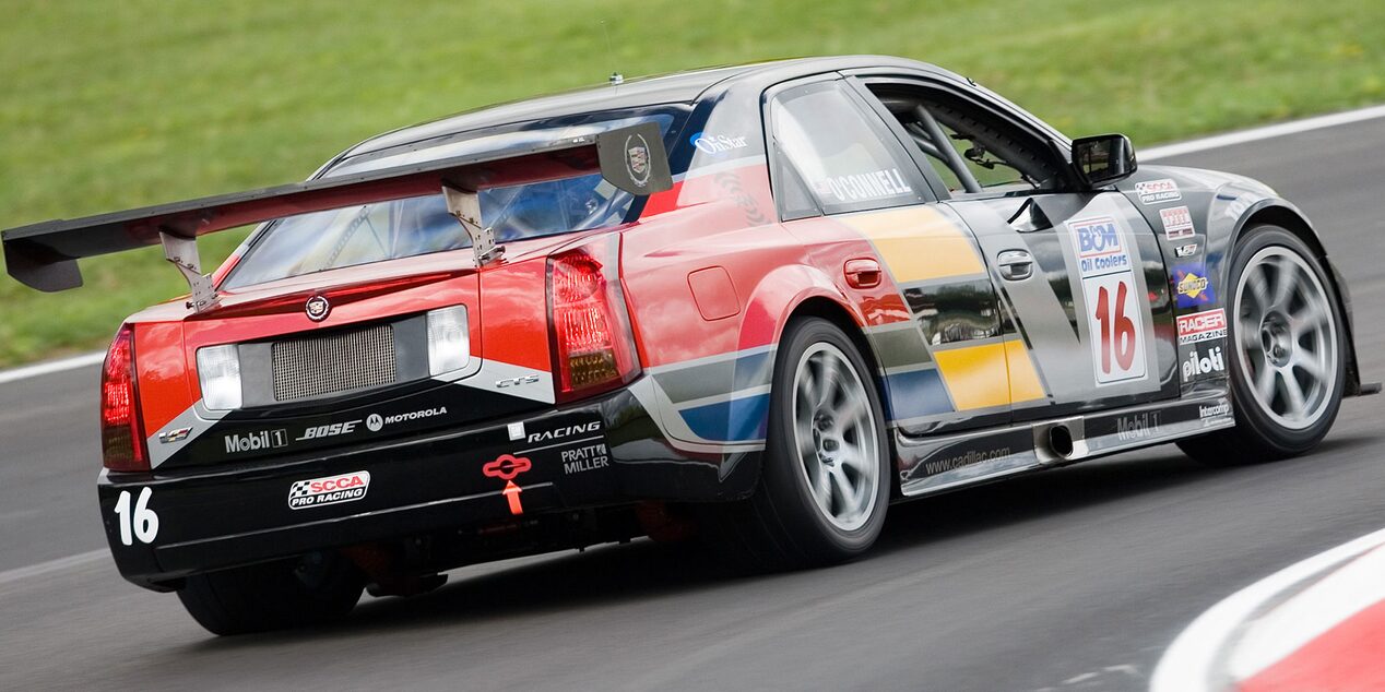 Rear View of the Cadillac Racing CTS-V Heritage Racecar Driving on a Track