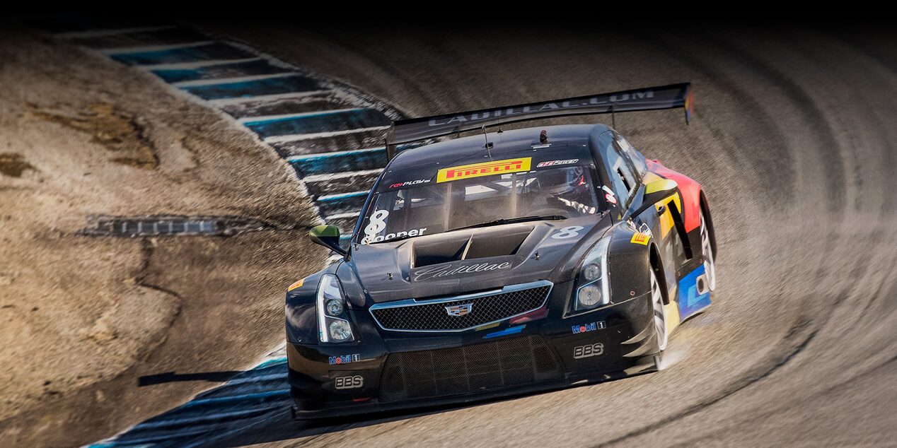 The Cadillac Racing ATS-V.R Heritage Race Car Fiercely Driving on the Curve of a Track