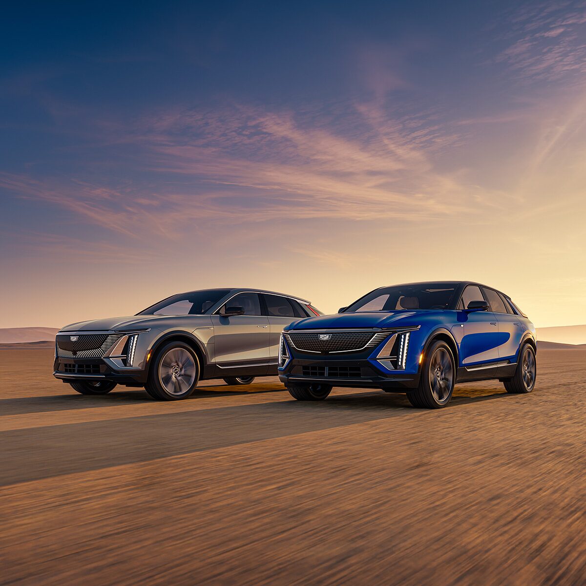 Two Cadillac SUVs Parked in the Desert Under a Beautiful Sunrise