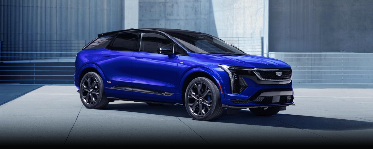 Three-quarters Passenger Side View of a Parked Blue 2026 OPTIQ-V Luxury Sport SUV