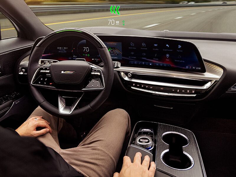 A Driver Utilizing Hands-free Super Cruise Technology While Driving a Cadillac
