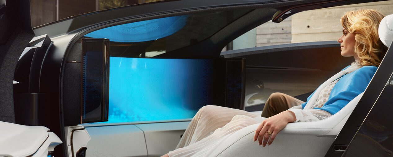 A Fashionably Dressed Woman Sitting in the Cadillac InnerSpace Concept Vehicle