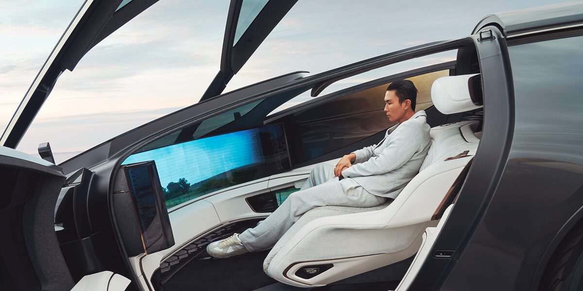 A Man Sitting in the Cadillac InnerSpace Concept Vehicle with the Top and Doors Open