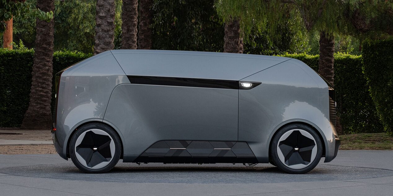Side Profile View of a the Cadillac SocialSpace Concept Vehicle Parked by Palm Trees