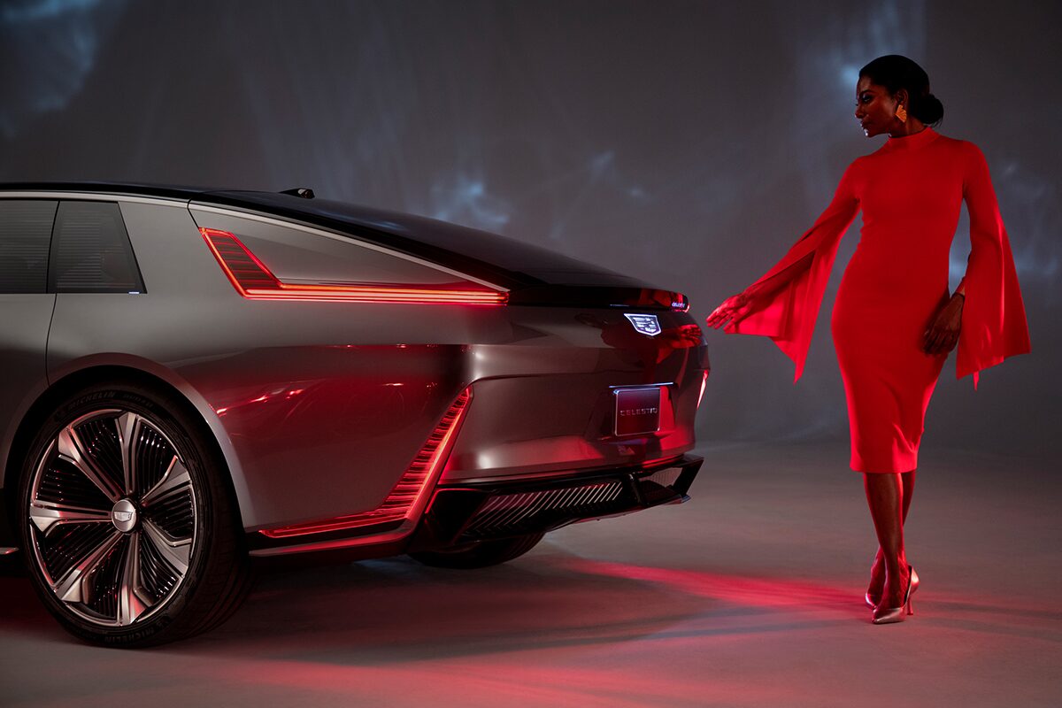 A Fashionably Dressed Woman Walking Around the Rear of a Cadillac CELESTIQ