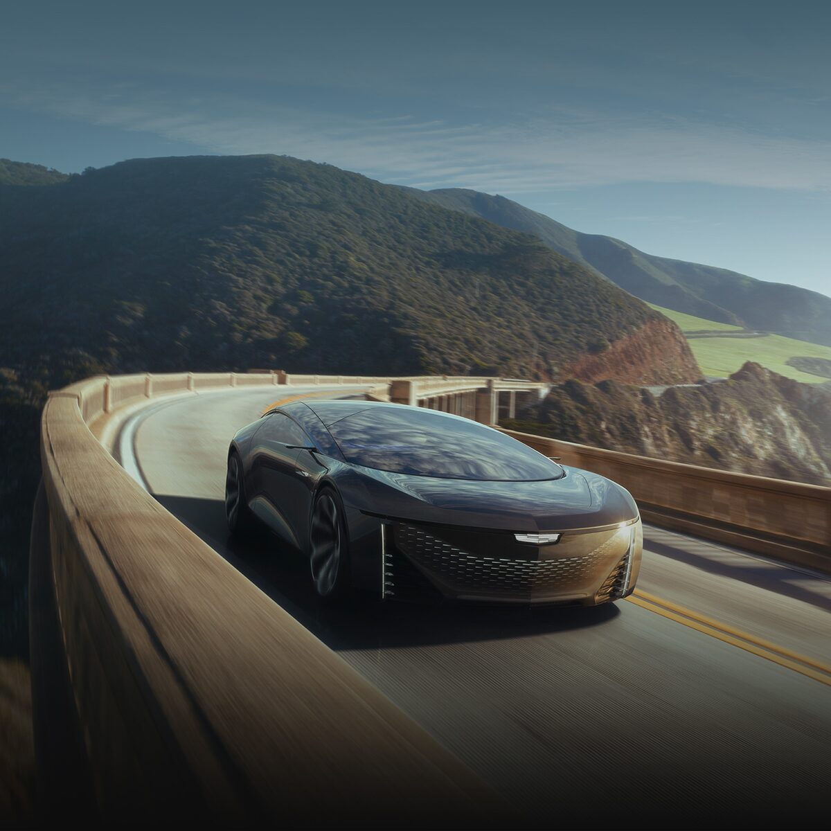 The Cadillac Innerspace Concept Vehicle Driving Down a Highway in the Mountains