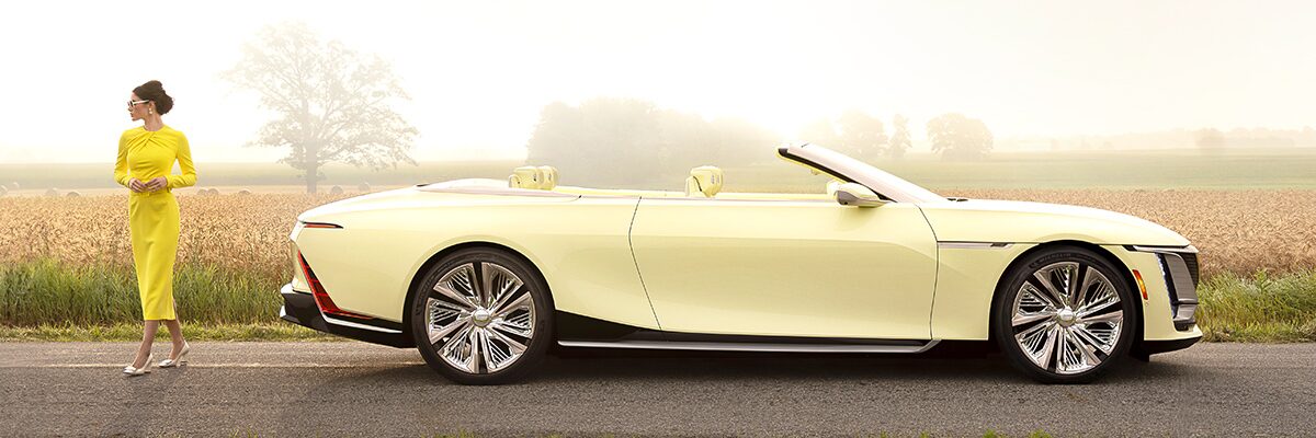 A Fashionably Dressed Woman Walking Away From the Cadillac Sollei Concept Convertible in the Country