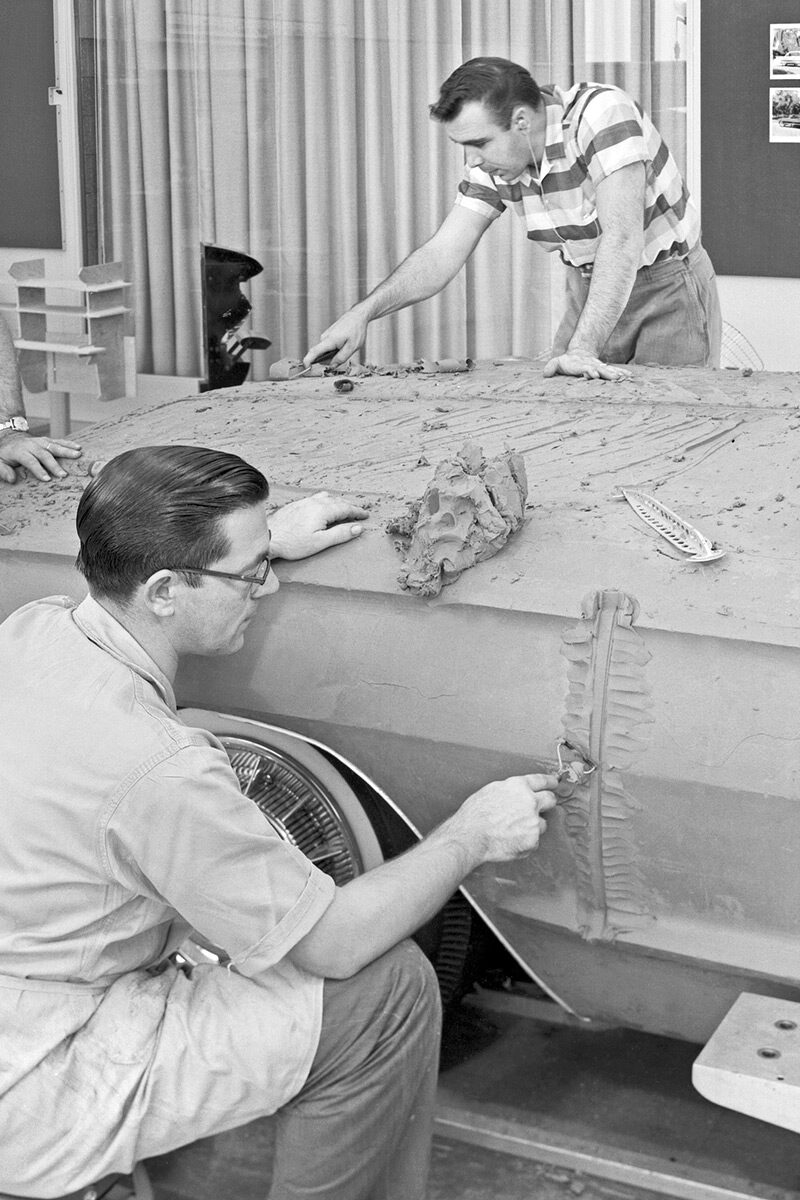 Two Men Sculpting Classic Cadillac In Clay