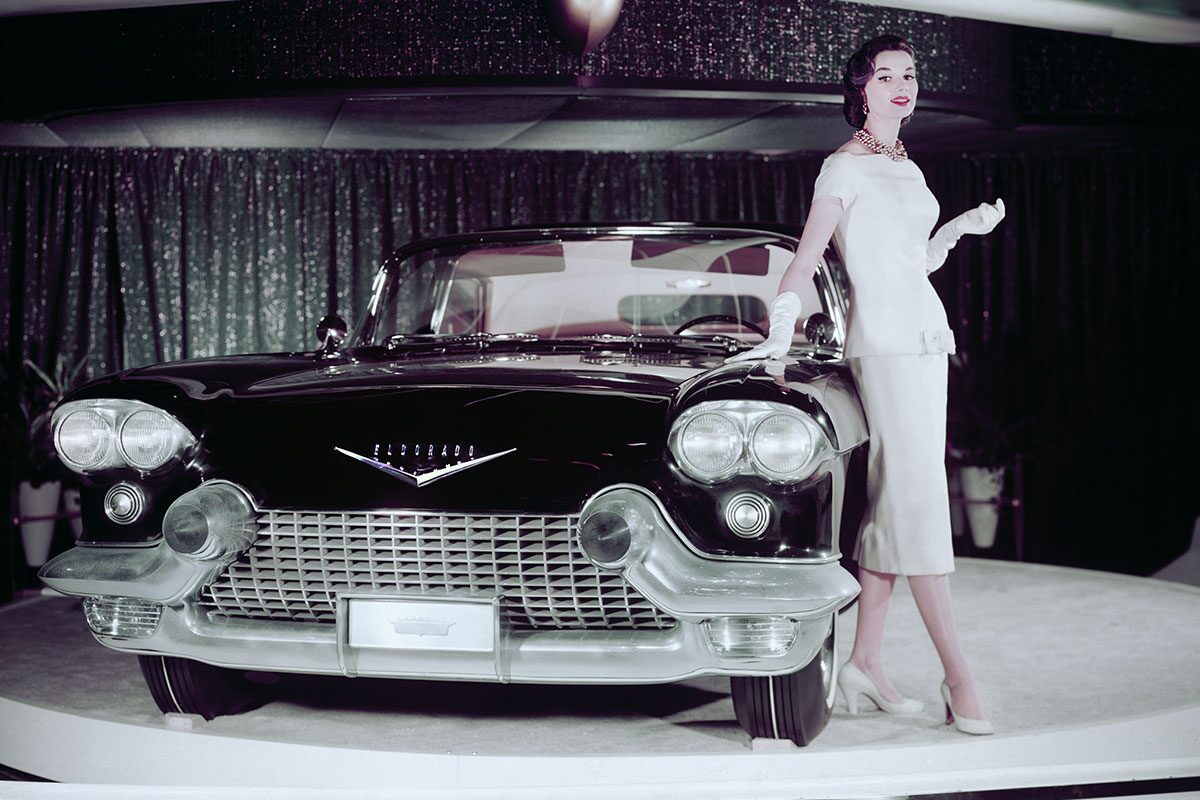 Woman Posing Next To Cadillac Eldorado On Rotating Car Platform
