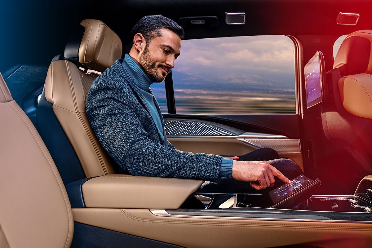 Man Smiling Using the Rear Seat Command Center