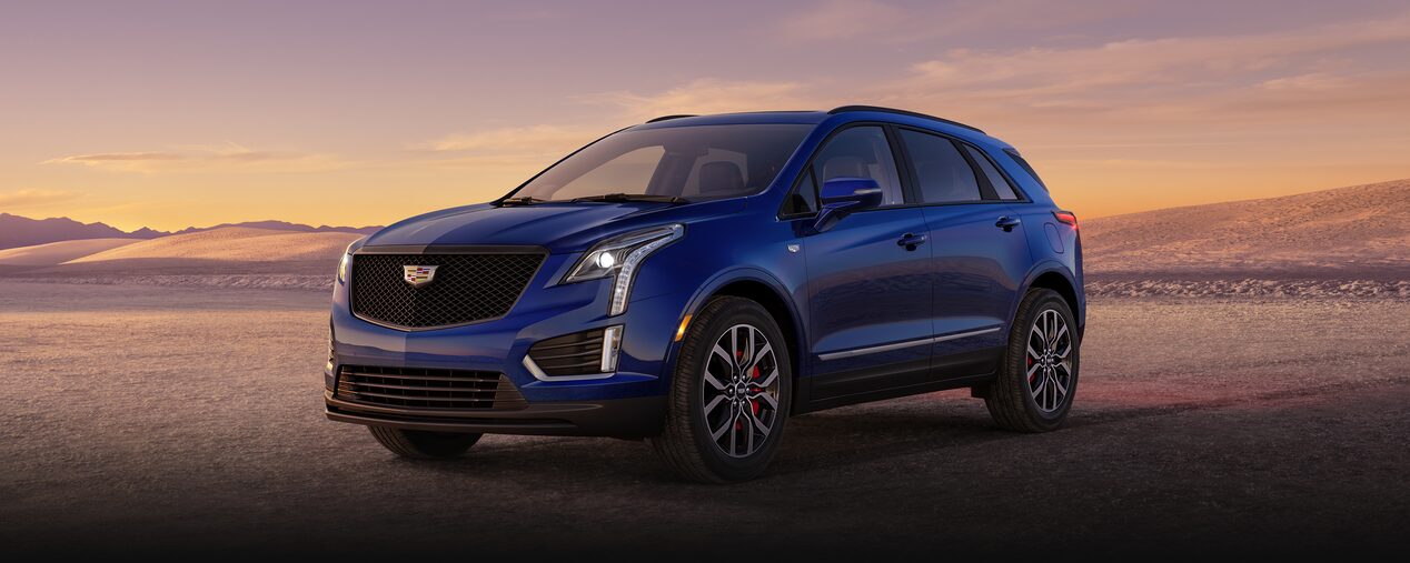 The Dark Moon Blue Metallic Cadillac XT5 Parked During the Sunset in Desert
