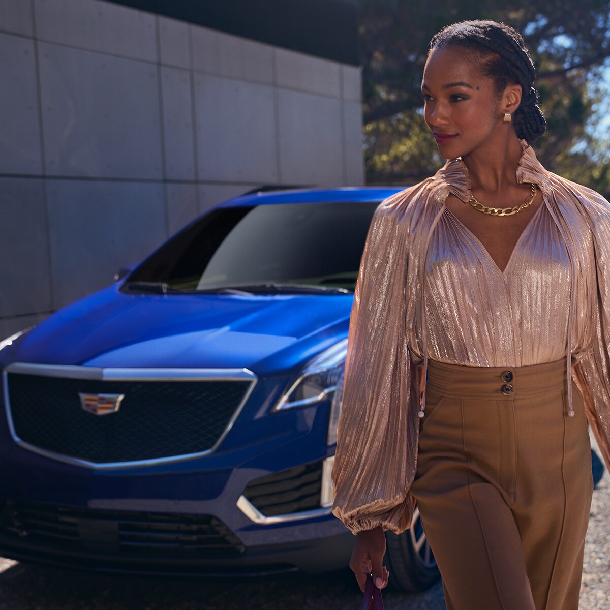 A Fashionable Dressed Woman Walking Away From Her Parked Cadillac XT5
