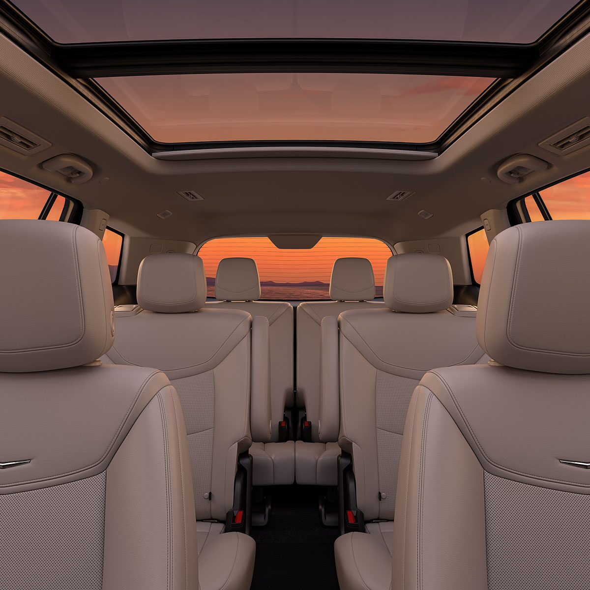 3 Rows of Tan Leather Seats Inside of the New Cadillac XT6 Parked Under the Sunset