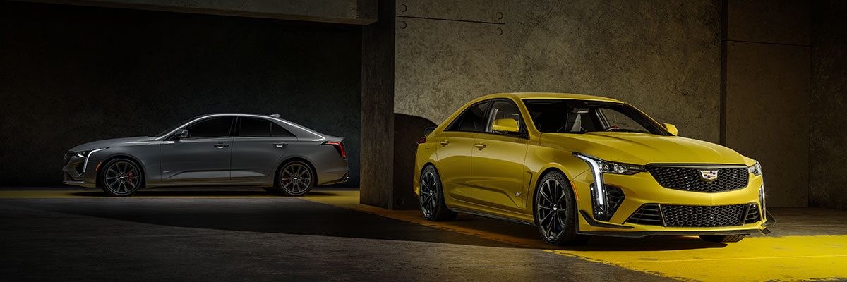 A Silver 2025 CT4-V and a Yellow 2025 CT4-V Blackwing Parked in a Parking Garage