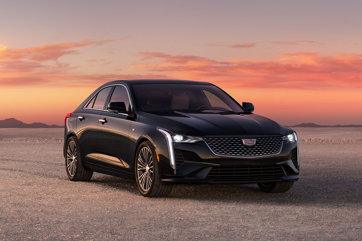 Front Driver's Side View of Parked Red 2026 Cadillac CT5 With Beautiful Sun Setting Displayed