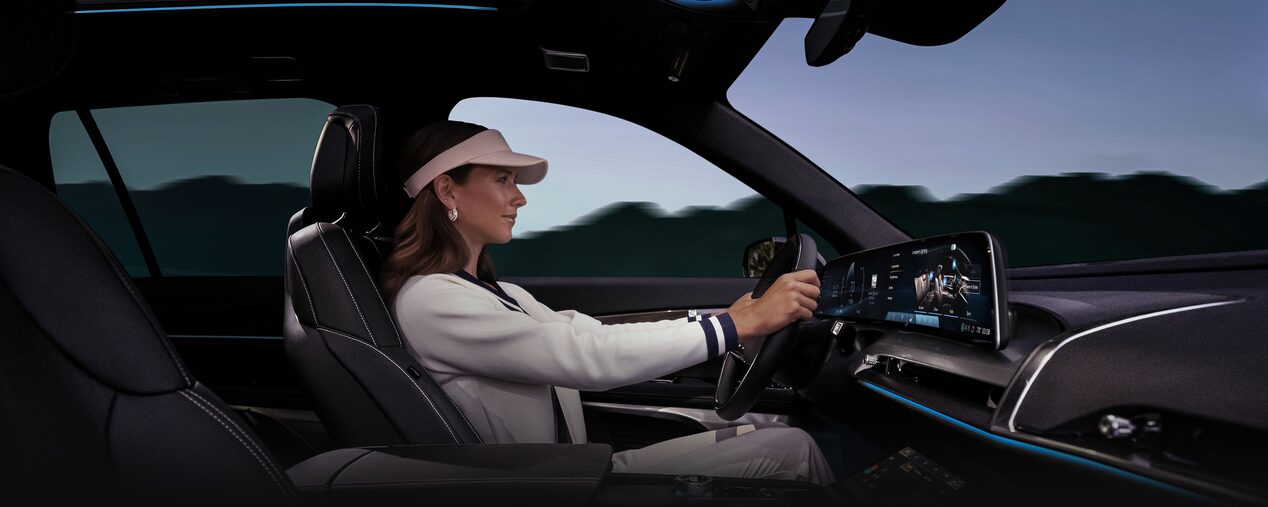 Passenger Side View of a Woman Driving the 2026 Cadillac VISTIQ Luxury Electric SUV