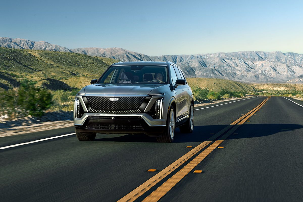The 2026 Cadillac VISTIQ All-electric SUV Driving Down a Road in the Mountains