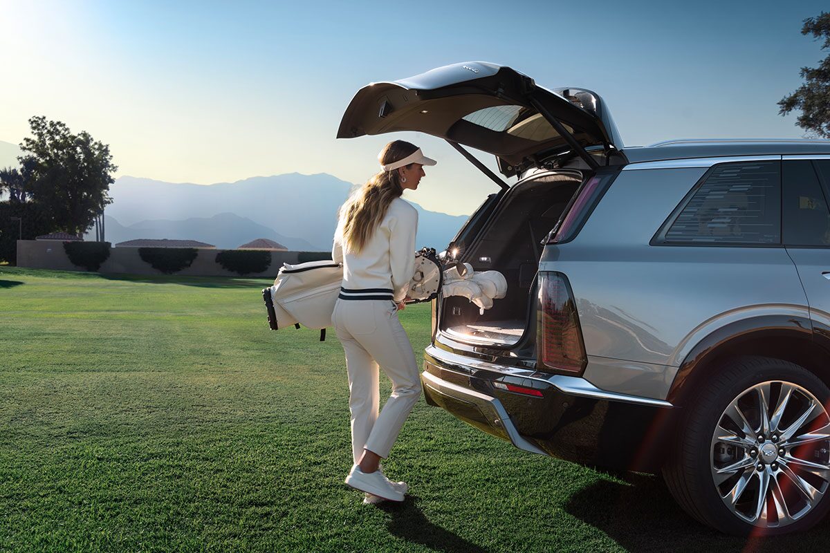 A Woman Putting Her Golf Bag in the 2026 VISTIQ Spacious Trunk