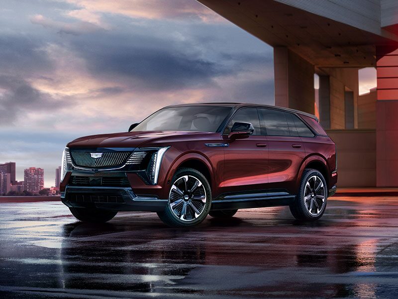 Three-quarter Driver Side View of a Maroon 2026 ESCALADE IQ EV SUV Parked