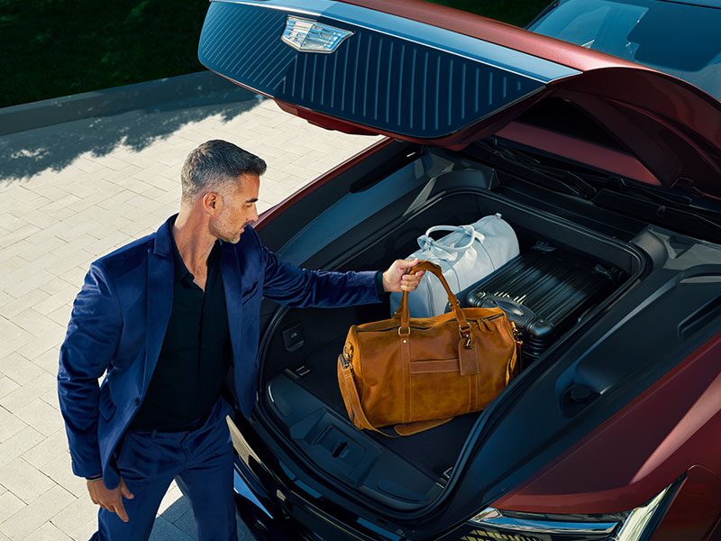 A Man Placing His Bags in the 2026 Cadillac ESCALADE IQ eTrunk