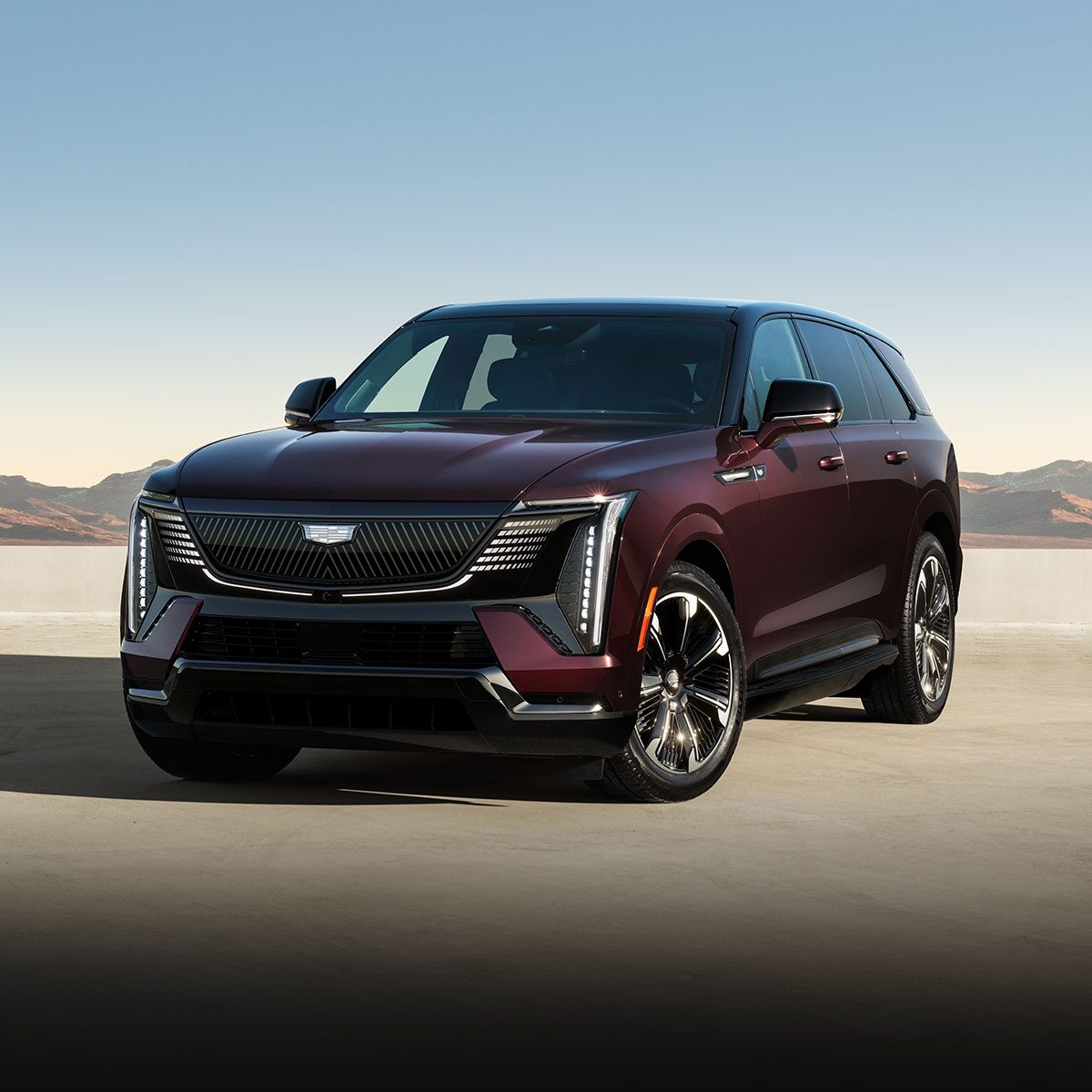 Three-quarters Driver Side View of the 2026 ESCALADE IQ Long Range EV Parked in the Desert