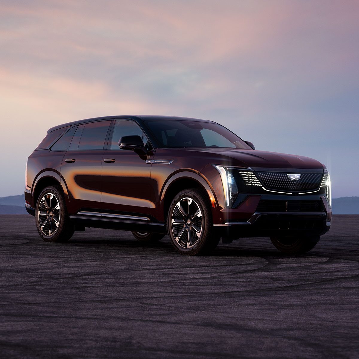 The 2026 ESCALADE IQ Parked in the Desert at Dusk with the Slimline LED Lights On
