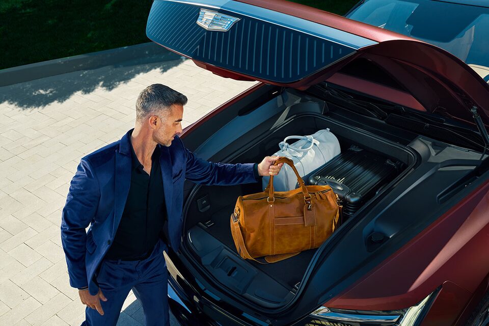 A Man Placing His Bags in the 2026 Cadillac ESCALADE IQ eTrunk