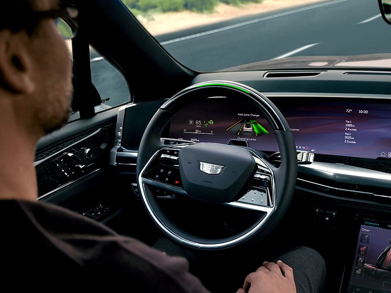 A Driver Utilizing the Automatic Lance Change Feature While Using the ESCALADE IQL Super Cruise Hands-Free Driving Feature