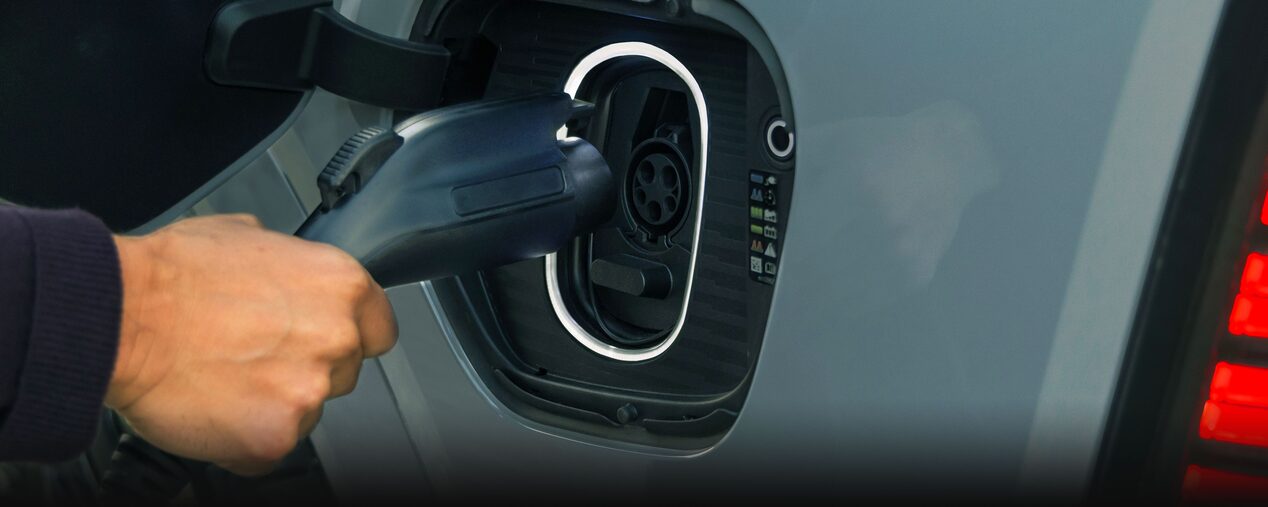 Close-up of Someone Inserting the EV Charger into the Port of a 2026 ESCALADE IQL