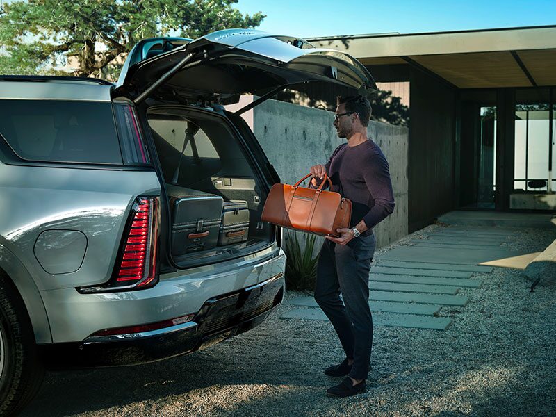 Close-up of a Man Loading Cargo Into the Spacious Trunk of a 2026 ESCALADE IQL