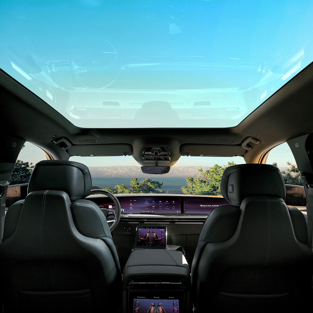Second Row View of the Panoramic Sunroof Open in the 2026 ESCALADE IQL Looking Out at a Beautiful Blue Sky