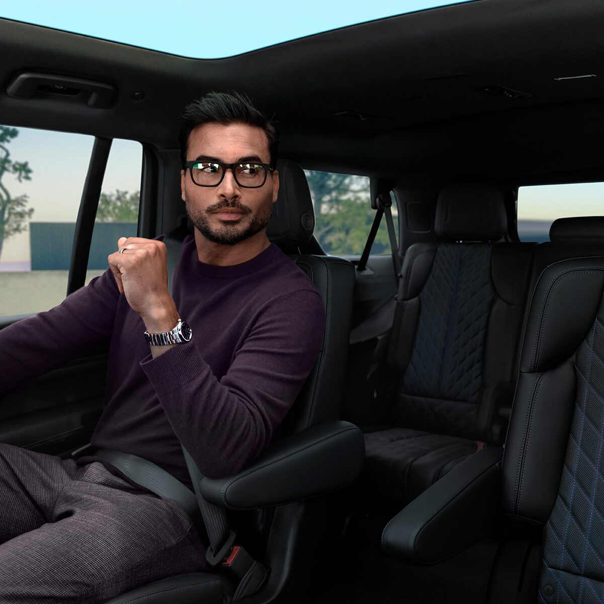 A Man in Glasses Sitting in the Second Row Captain Chair of the 2026 ESCALADE IQL Long Range EV