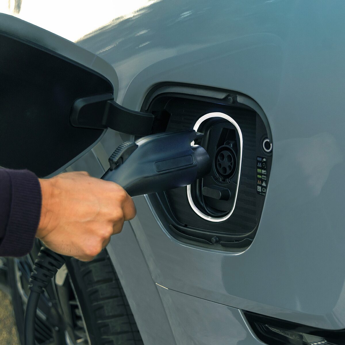 Close-up of Someone Inserting the EV Charger into the Port of a 2026 ESCALADE IQL