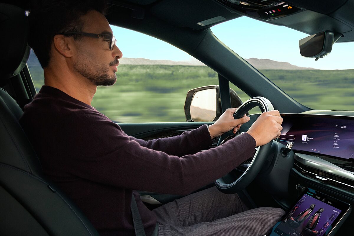 Close-up of a Man Driving the 2026 ESCALADE IQL Large Electric SUV