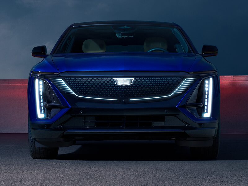 Front View of a Parked Blue Cadillac LYRIQ and Close-up on LED Slim Headlights