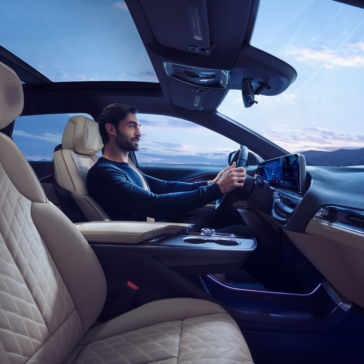 Passenger Seat View of a Man Driving the Cadillac LYRIQ Using the Navigation System