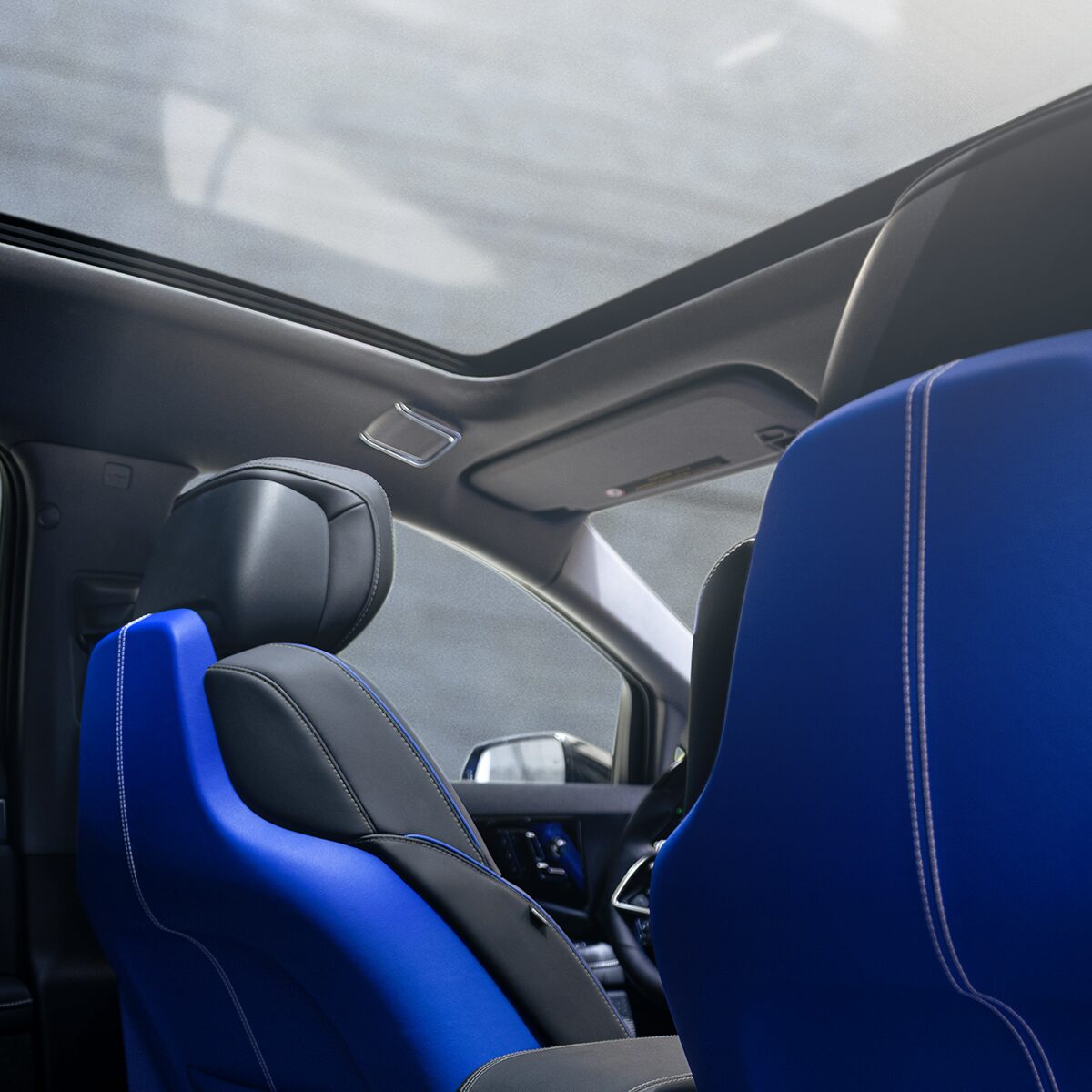 Back Seat View of the 2026 OPTIQ-V Blue Front Seats, Sun Roof, and Interior