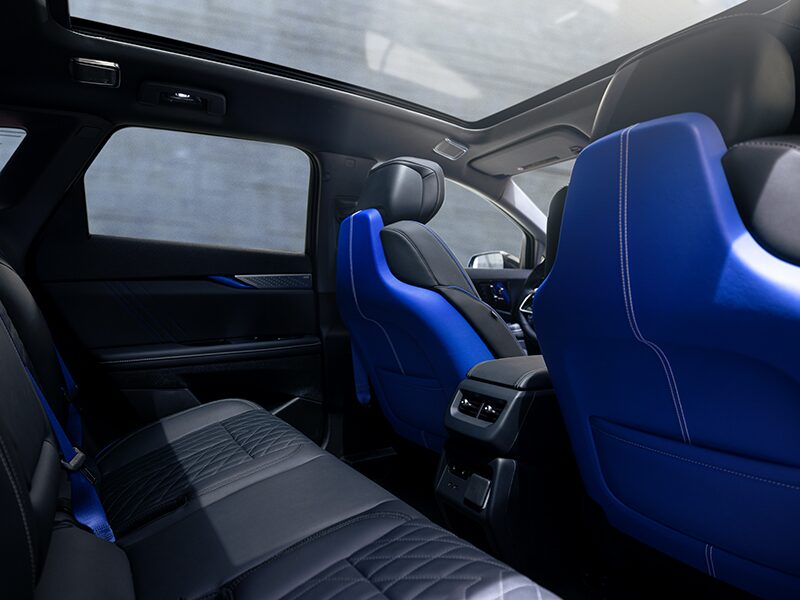 Back Seat View of the 2026 OPTIQ-V Blue Front Seats, Sun Roof, and Interior