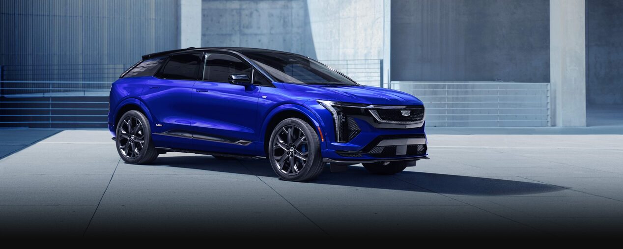 Three-quarters Passenger Side View of a Parked Blue 2026 OPTIQ-V