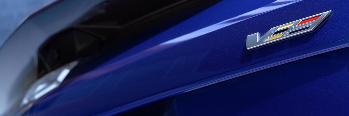 The V-Series Badge on the Rear End of a Blue 2026 OPTIQ-V