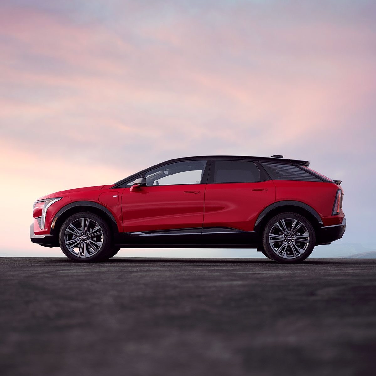 A Side Profile View of a Red 2026 Cadillac OPTIQ
