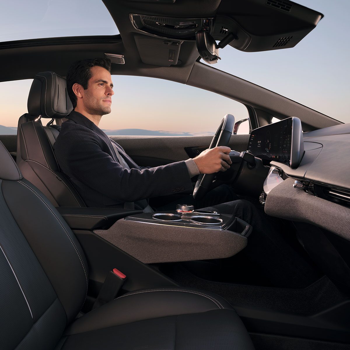 A Man Driving a 2026 Cadillac OTPIQ