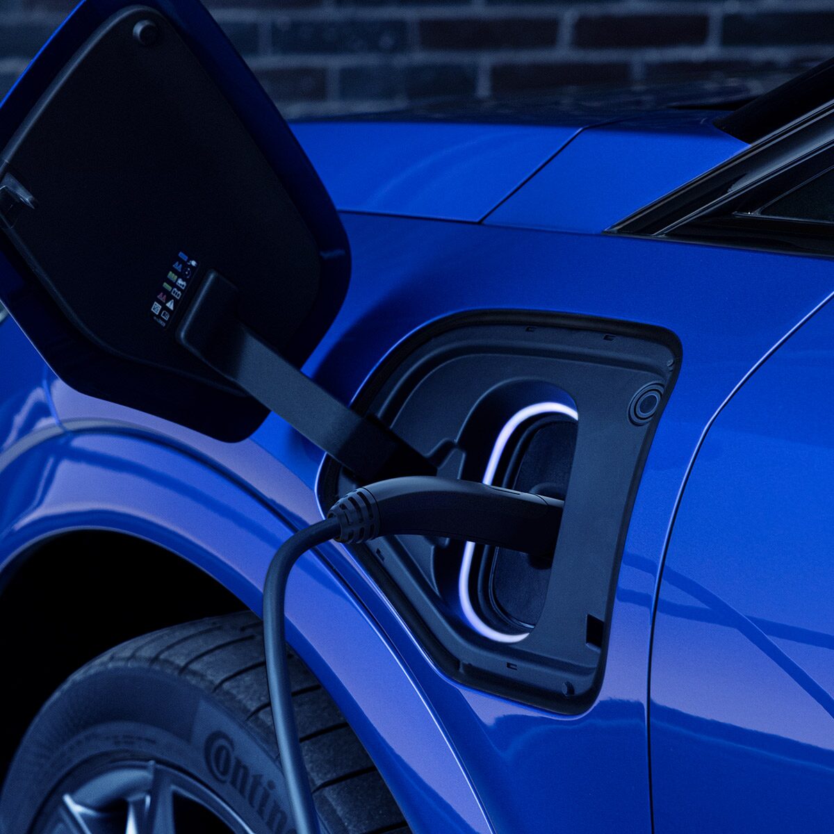 Close-up of the EV Charger in a Blue 2026 OPTIQ-V Charging Port